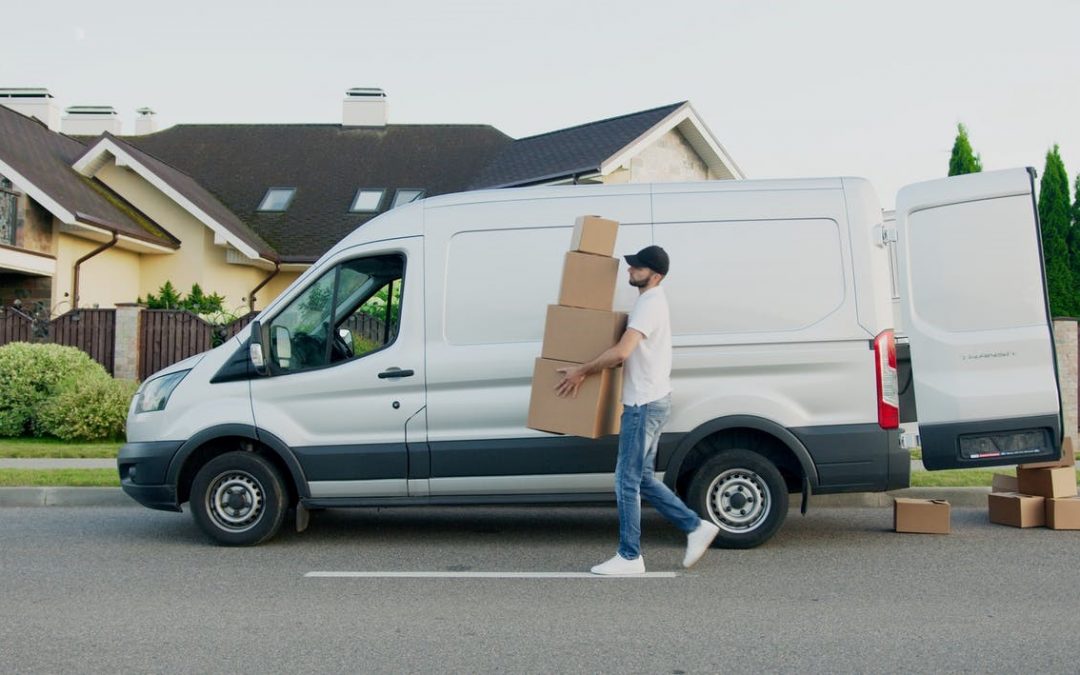 A deliveryman delivering courier boxes.
