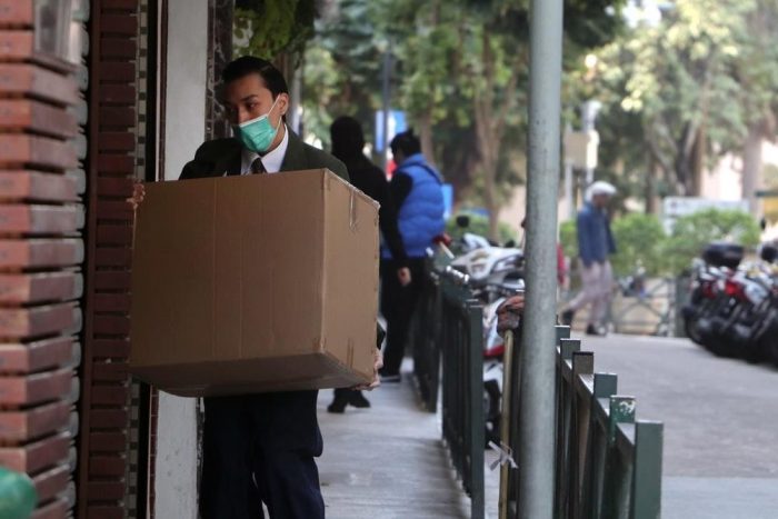 A man delivering a package while wearing a mask